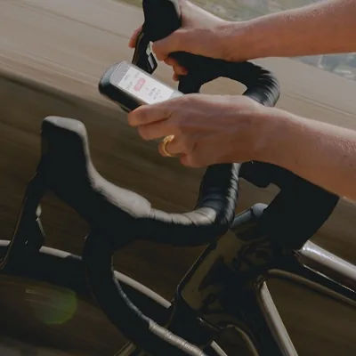 ELEMNT bike computer controlling an action camera, music, and lights from the handlebars