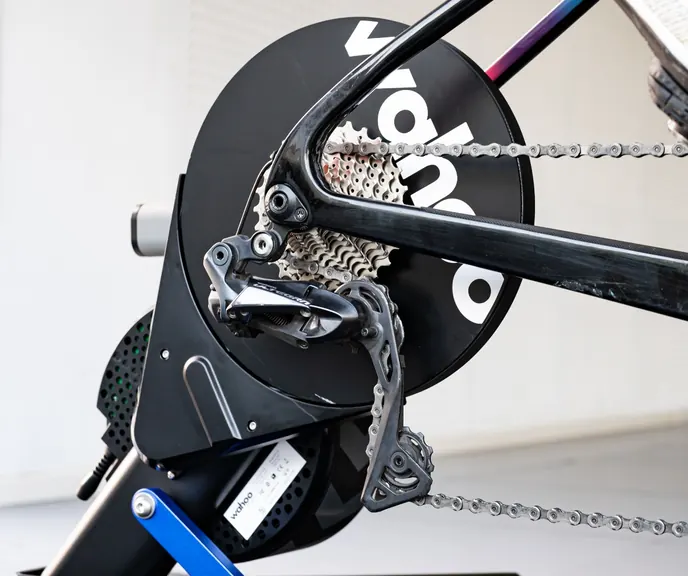 A cassette and rear derailleur on a bike mounted to a Wahoo KICKR trainer